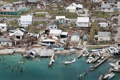 an aerial view of houses and boats on the water in a coastal area with debris everywhere