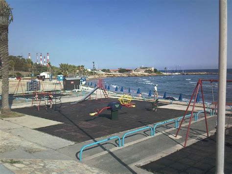 View of Dhekelia Power Station, Towers in background from childrens playground on the beach at ...