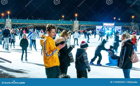 View on the People are Ice Skating in the City Park Ice Rink in ...