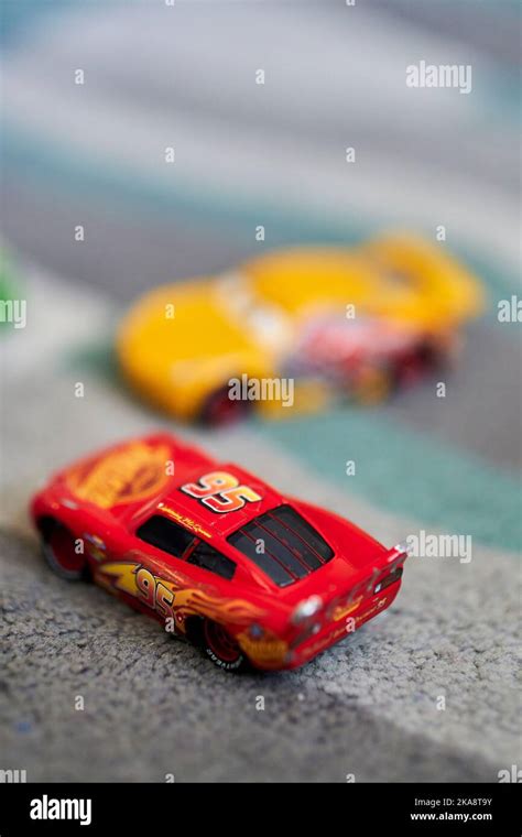 A vertical shallow focus of toy cars on a carpet - Lightning McQueen cartoon characters Stock ...