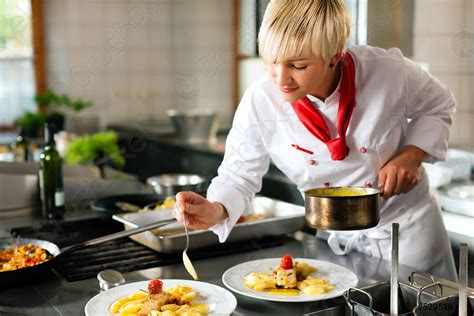 Female chef in a restaurant or hotel kitchen cooking - stock photo ...