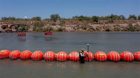 At Texas' floating border wall, children slashed by razor wire