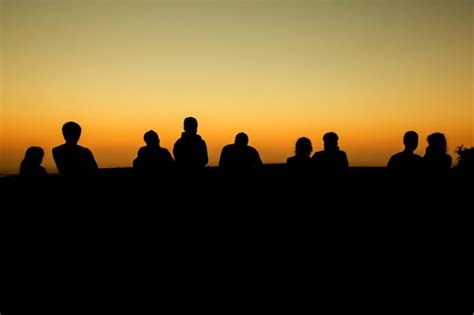 Premium Photo | Silhouette of group of friends standing in sunset