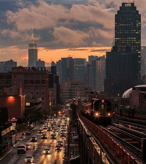 a city street filled with lots of traffic next to tall buildings at ...