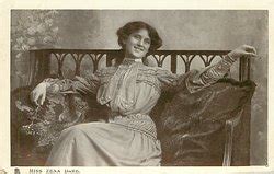 MISS ZENA DARE, sitting on couch with pillows - TuckDB Postcards