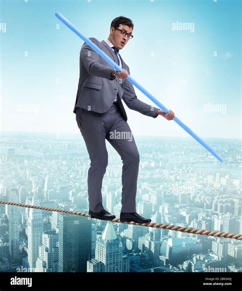 The businessman doing tightrope walking in risk concept Stock Photo - Alamy