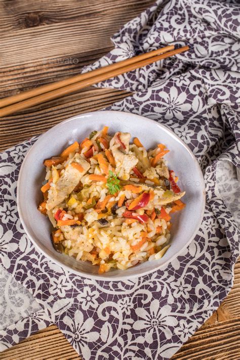 Fried chicken with rice and vegetables. Stock Photo by foto_pstryki