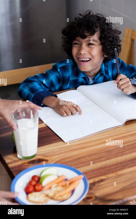 Child doing homework at dinner table hi-res stock photography and images - Alamy