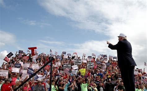 White woman holds "Blacks for Trump" sign at Florida rally - CBS News