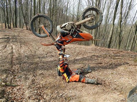 Dirt bike rider holding up his dirtbike after failed wheelie (x-post from /r/motorcycles ...