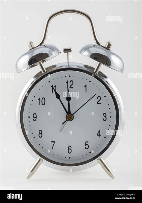 Vintage alarm clock isolated on white background Stock Photo - Alamy