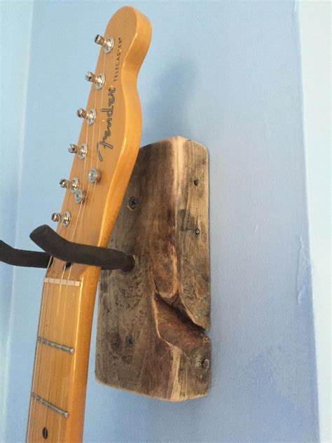 DIY Guitar Hanger First attempt turned out ok. Hanger from Home Depot and leftover pallet wood ...