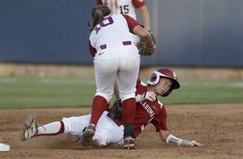 Oklahoma's Brianna Turang, right, grimaces as she is tagged out at ...