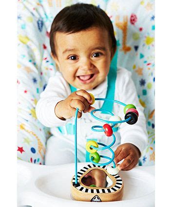 A wooden high chair suction toy with mirror and colourful beads to attract your baby's attention ...
