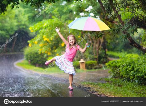 Kid with umbrella playing in summer rain. — Stock Photo © FamVeldman ...