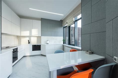 Contemporary apartment interior with table and chairs near kitchen ...
