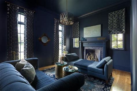 Harper Howey Interiors - Dramatic dark blue living room is clad in dark blue baseboards lining ...