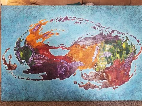 a painting on the floor in front of a couch that has been made to look like a map