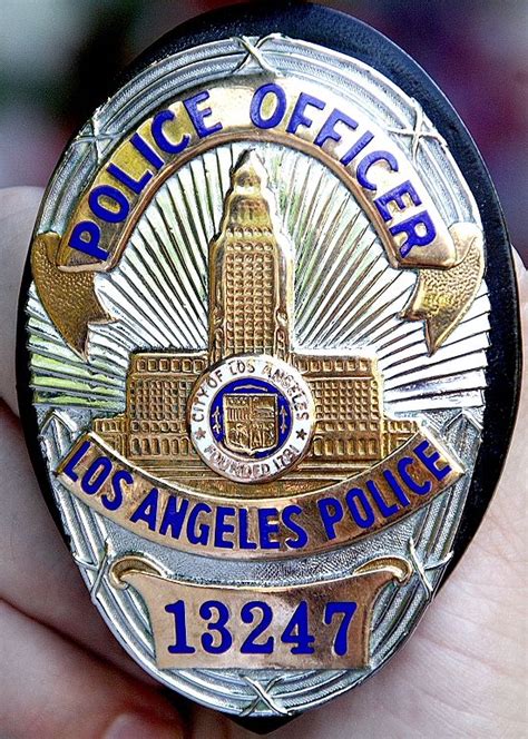 a police badge is shown in the palm of someone's hand as they hold it