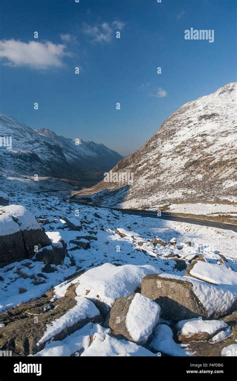 Llanberis Pass A4086 road in winter with snow on road Snowdonia National Park Gwynedd North ...