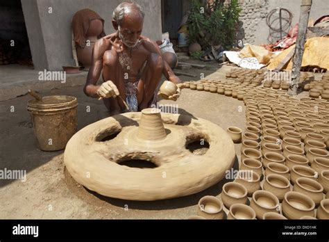 Potter making pots on a traditional wheel with special clay Stock Photo: 67898815 - Alamy