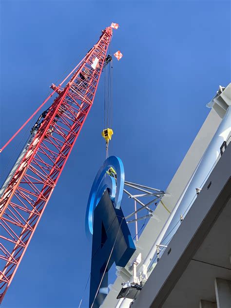 Workers begin installing JMA sign at JMA Wireless Dome