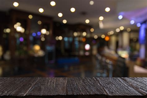 blur background of pub restaurant with wood table – PointOS