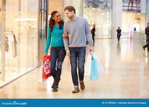 Happy Couple Carrying Bags In Shopping Mall Stock Photo - Image: 41109366