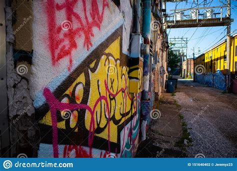 Alley Way with Graffiti on a Brick Wall Stock Photo - Image of door, building: 151640402