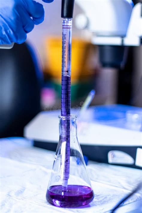 A Purple Liquid Being Put into a Conical Flask To Test Chemicals for ...