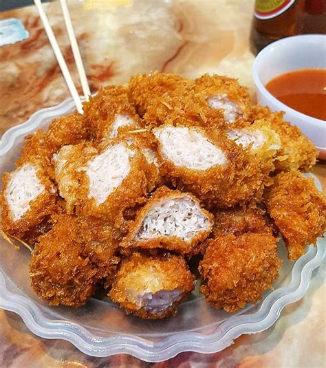 Nem chua rán are deep fried pieces of fermented pork sausage meat. The slight sour taste comes ...