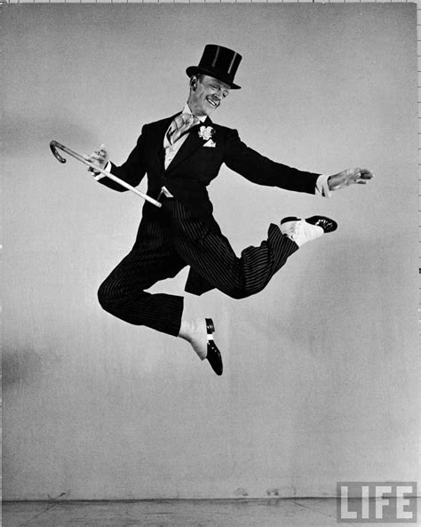 Dancer Fred Astaire clad in top hat, tails & spats, holding cane as he does a climatic jump in ...