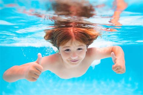 Child Splashing in Swimming Pool. Kid Swimming in Pool Underwater ...