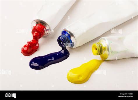 Tubes of three red, blue and yellow paint on a white background Stock Photo - Alamy