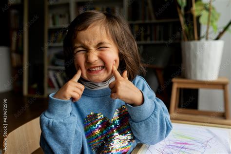 little girl making funny and silly faces Stock Photo | Adobe Stock