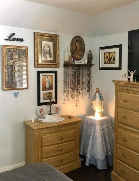 a bedroom with pictures on the wall and a table in front of it that has ...