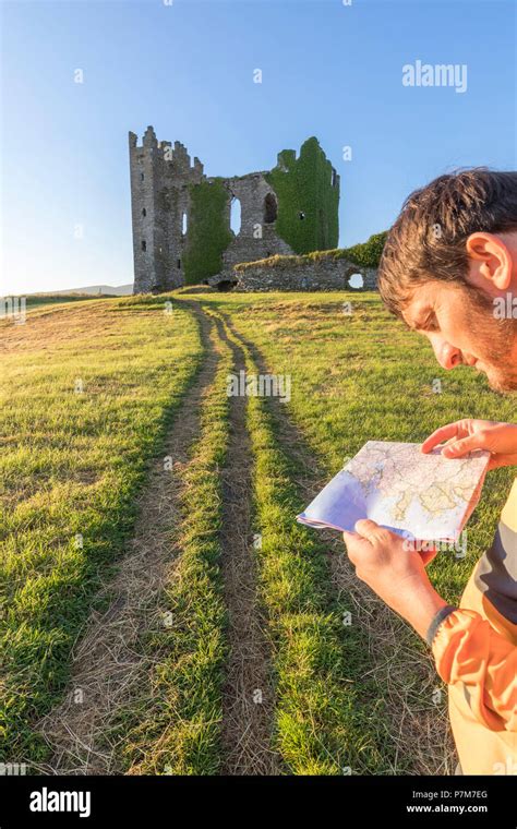 Hiker with map, Ballycarbery Castle, Cahersiveen, County Kerry, Ireland Stock Photo - Alamy