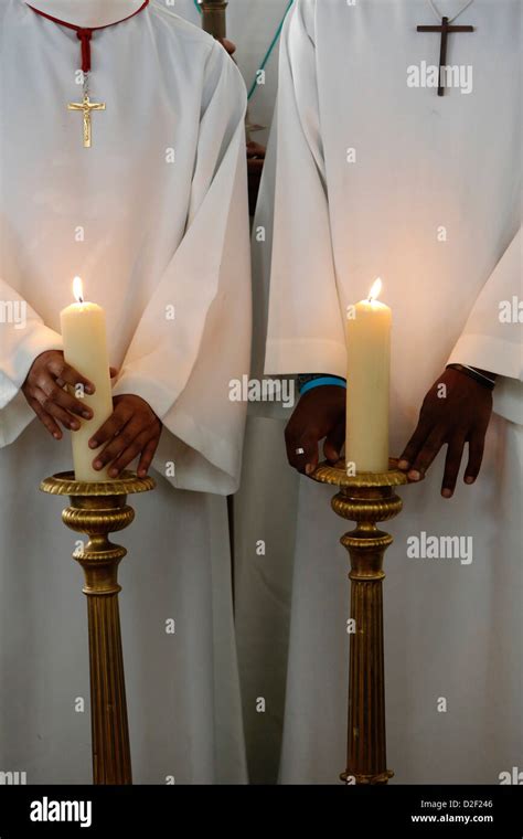 Catholic altar boys holding church candles Stock Photo - Alamy