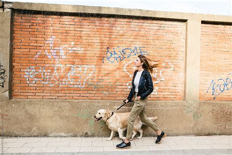 "Side View Of A Woman Walking Her Dog On Sidewalk." by Stocksy ...