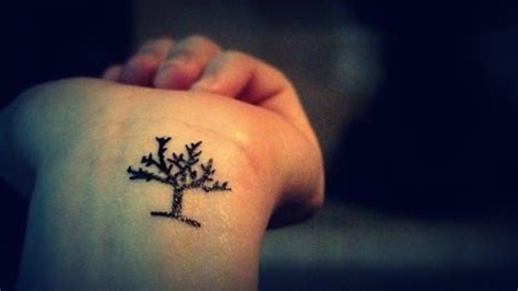 a small tree tattoo on the wrist