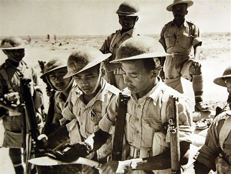 Gurkhas in the Western Desert, July 1942 cleaning kukri Enfield No III Brodie helmet shorts ...