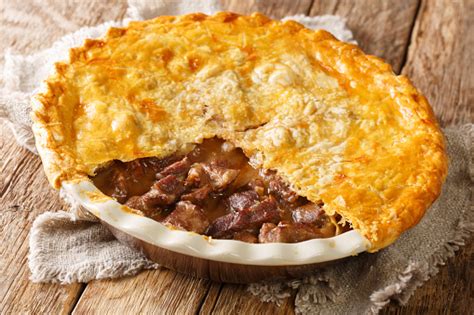 Traditional Recipe Of English Beef Steak Pie With Crispy Puff Pastry Closeup In A Baking Dish ...