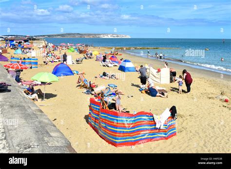 Busy sandy UK English summer holiday beach at Shanklin on the Isle of White hot summers day with ...