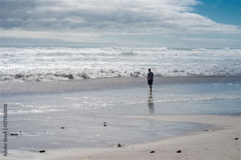 Man walking alone on the beach in South Africa Stock Photo | Adobe Stock