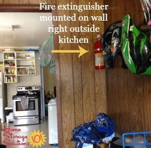 Fire extinguisher mounted on wall by the kitchen, example of good fire extinguisher placement ...