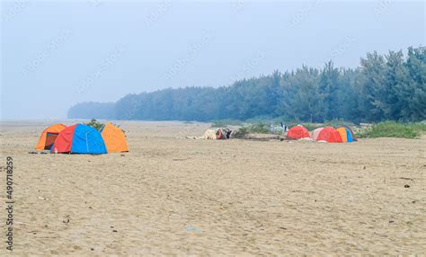 Campsite on the beach. Tents on a sea beach with sky and green ...