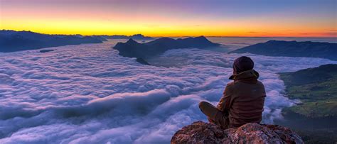 1024x600 resolution | man seating on the peak of the mountain HD ...