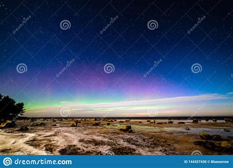 Aurora Borealis and Stars in Dark Night Over Sea Beach in Winter Stock Photo - Image of water ...