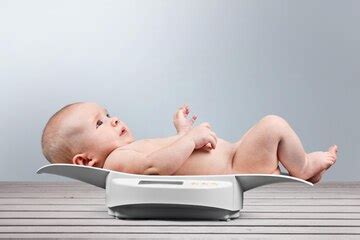 Premium Photo | Baby on weight scale