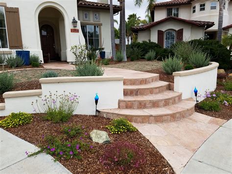 Front entry with low wall stucco wall and curved flagstone walkway with stairs | Exterior stairs ...